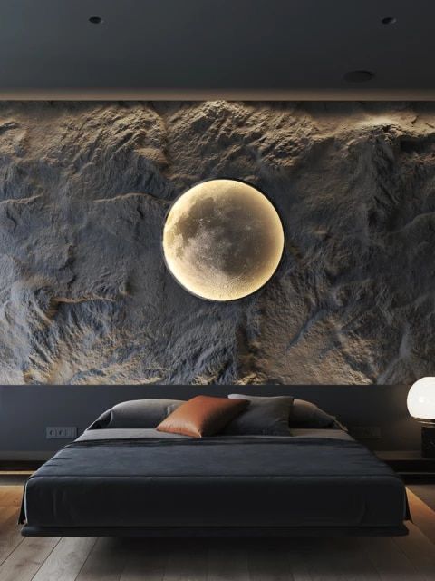 a bedroom with a large stone wall and a full moon above the bed in front of it