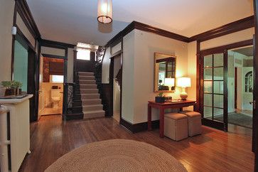 the inside of a house with wood floors and stairs