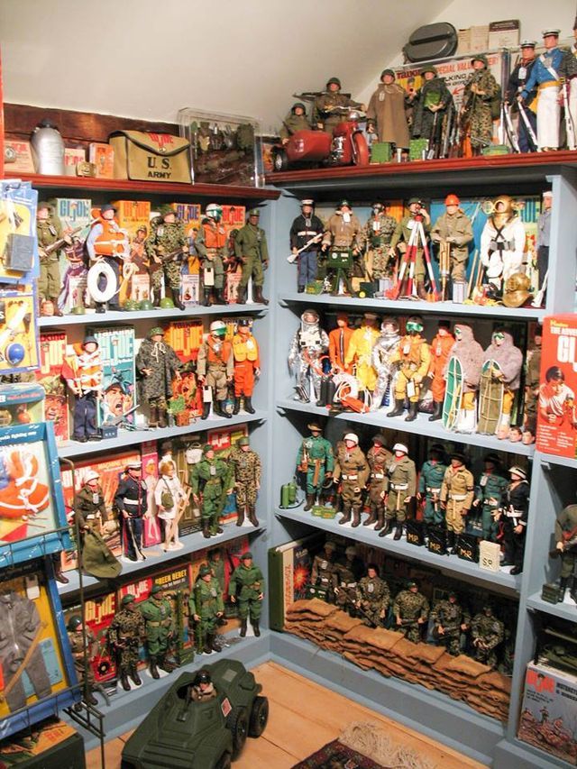 a room filled with lots of toy action figures and toys on the shelves in front of them