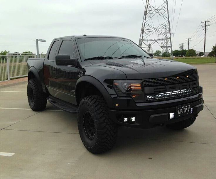 a large black truck parked in a parking lot