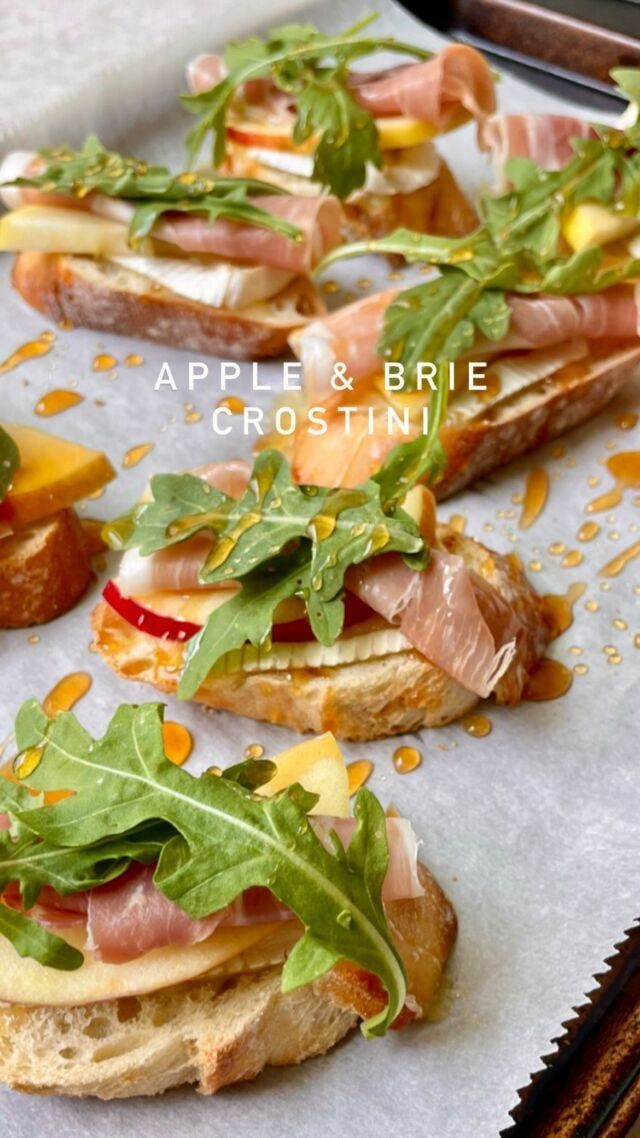 some food is laying out on a tray and ready to be eaten with the words apple & brie crostinie above it