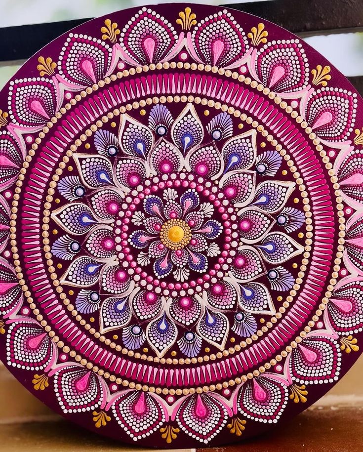 an intricately designed plate with pink and purple colors