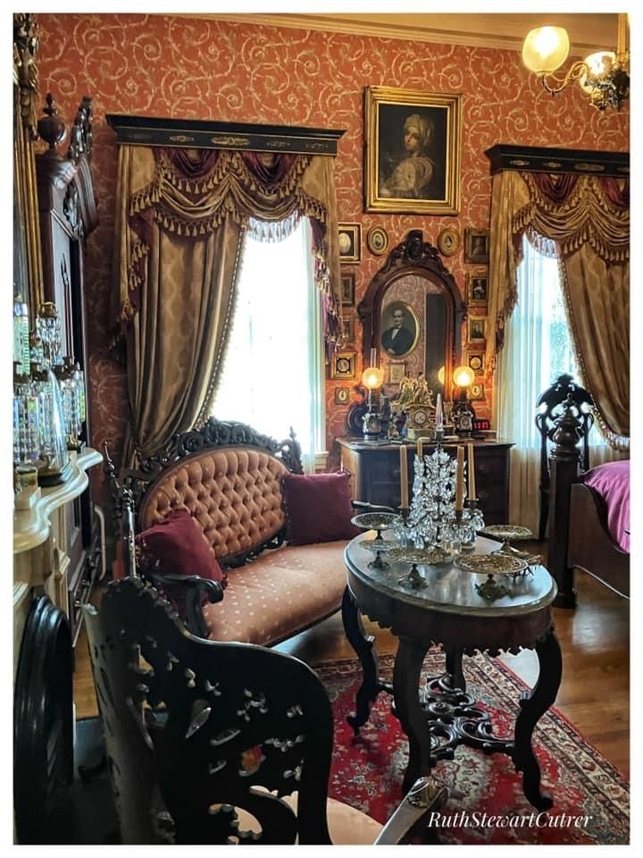 an ornately decorated living room with antique furniture