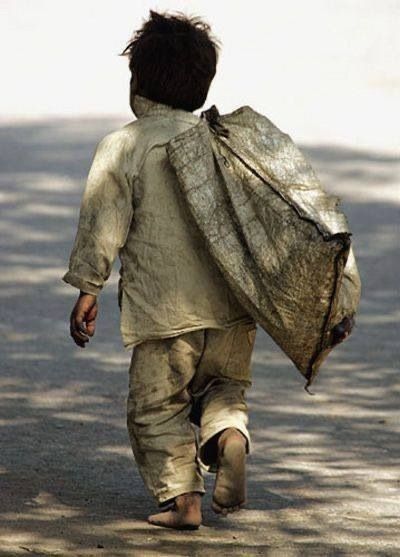 a man walking down the street with a bag on his back and words above it