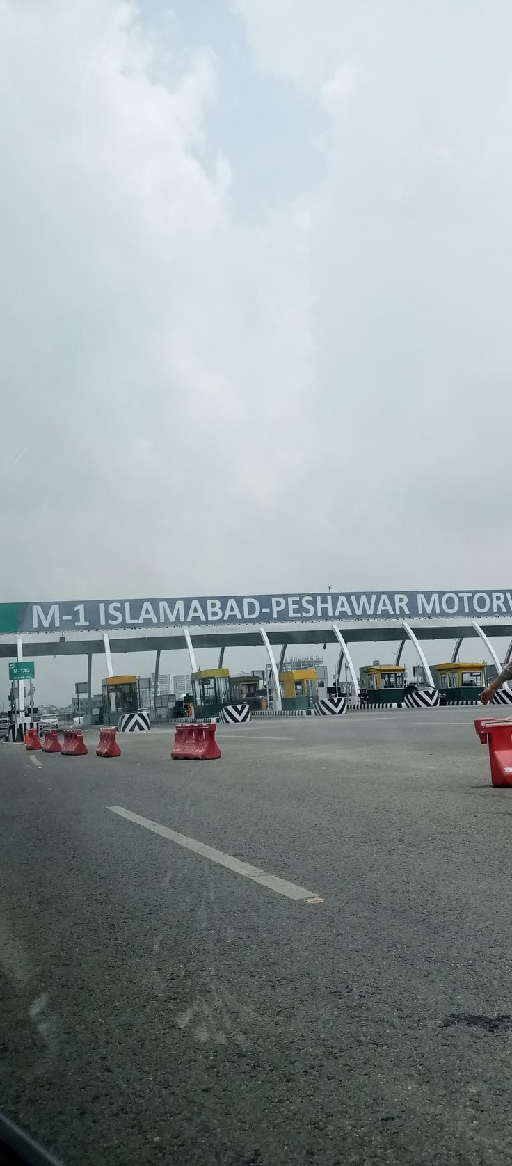 the highway is lined with red barriers and signs