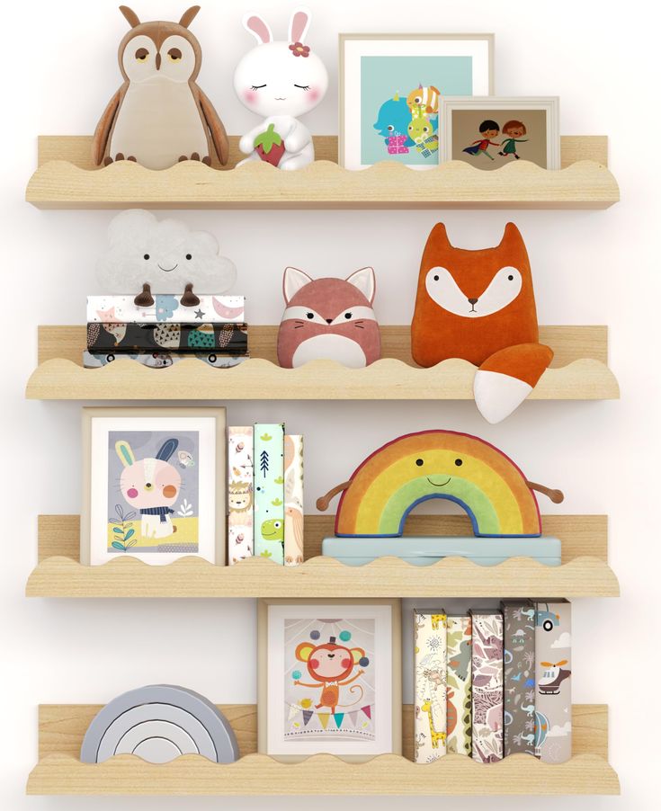 three shelves with stuffed animals, pictures and other items on them in front of a white wall