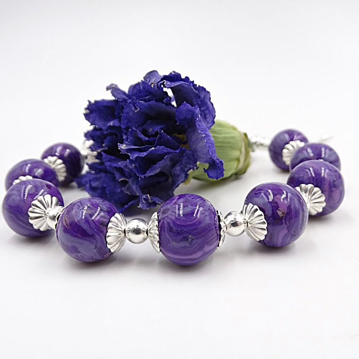 Harmoniously uniting the timeless elegance of flowers with contemporary design, our Harmony Bracelet is a truly unique piece of keepsake jewelry. This exquisite bracelet features 6 to 10 individually handcrafted flower infused beads, each holding your precious flower petals. Complimented by detailed sterling silver caps and interspersed silver beads, it's a blend of beauty and sentimental value. All components used in the earrings are crafted from sterling silver, ensuring a timeless and high-qu Elegant Beaded Bracelets With Large Beads As Gift, Elegant Silver Bracelets With Large Beads, Elegant Sterling Silver Bracelet With Polished Beads, Elegant Silver Bracelet With Large Beads, Adjustable Large Bead Sterling Silver Jewelry, Adjustable Large Beads Sterling Silver Jewelry, Elegant Adjustable Sterling Silver Bracelet With Spacer Beads, Adjustable Large Beaded Sterling Silver Jewelry, Elegant Beaded Bracelets With Flower-shaped Spacer Beads