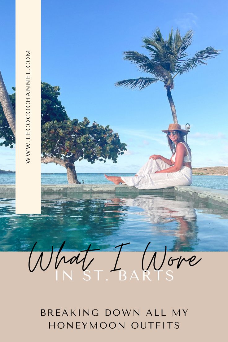 a woman sitting on the edge of a pool with palm trees in the background