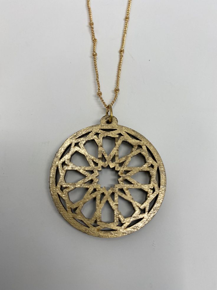 Artisan Gold Etched Jewelry, Artisan Etched Gold Jewelry, Symbolic Handmade Gold Medallion Necklace, Artisan Gold Medallion Necklace, Symbolic Etched Gold Necklaces, Symbolic Etched Gold Necklace, Laser Cut Metal Jewelry Gift, Gold Engraved Bohemian Medallion Necklace, Gold Laser Engraved Round Pendant Jewelry