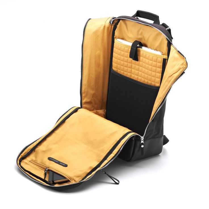 an open yellow and black suitcase on a white background