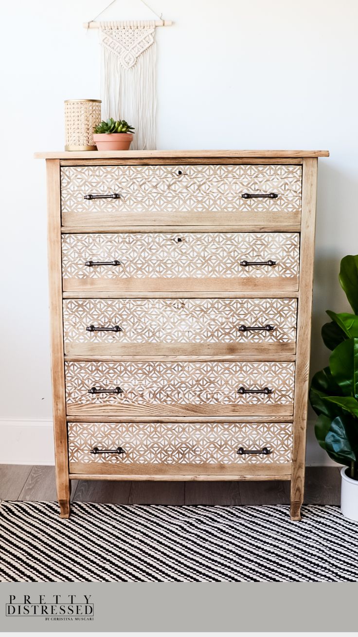 an old dresser is painted with white paint and decorated with plants on top, along with a potted houseplant