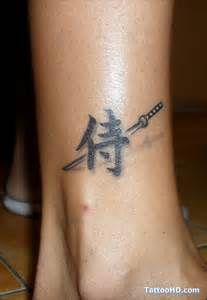 a tattoo on the foot of a woman with two swords in it's center