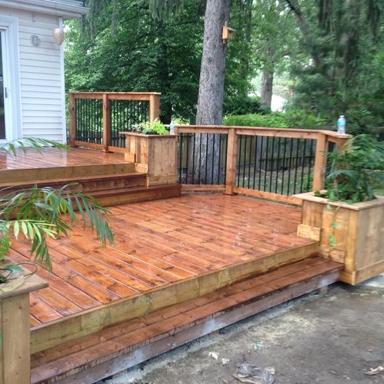 a wooden deck with planters on it