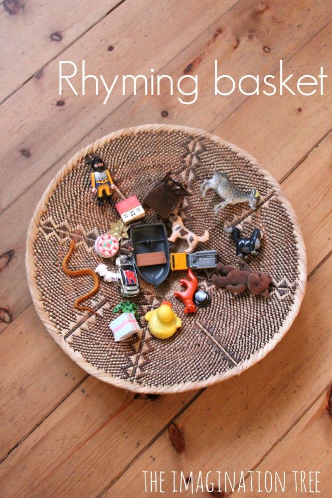 a basket filled with toys sitting on top of a wooden floor