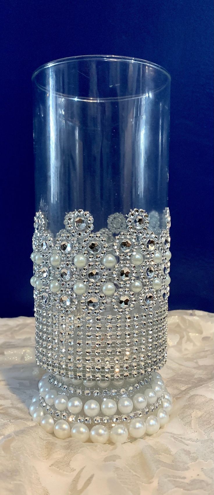 a clear glass with pearls on it