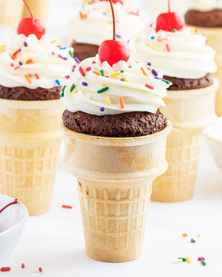 ice cream cone cupcakes with cherries and sprinkles on top