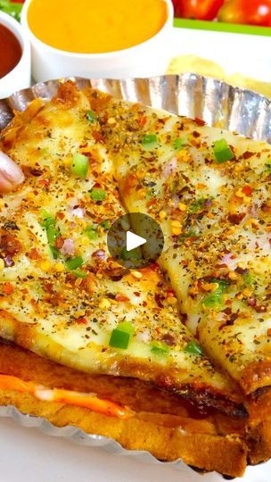 a person is holding up a pizza with cheese and vegetables in bowls behind it on the table