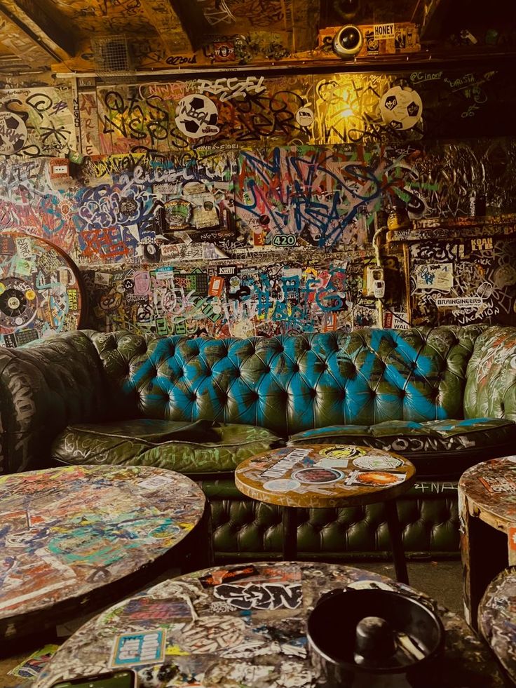 a room filled with lots of graffiti covered furniture