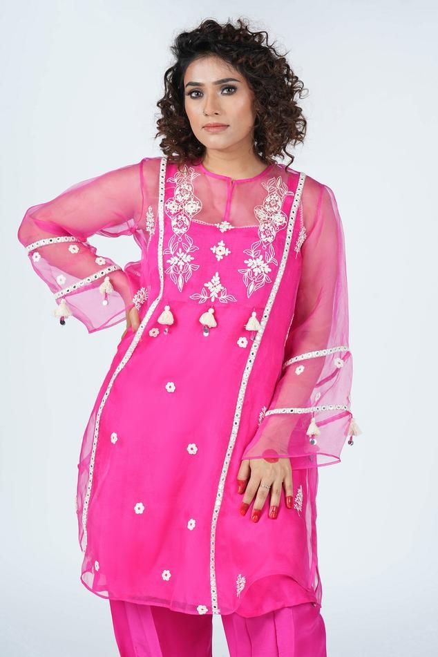 Pink sheer tunic with dori floral embroidery and mirrorwork embellishments. Comes with salwar and inner.
Components: 3
Pattern: Embroidered
Type Of Work: Thread,Dori
Neckline: Round
Sleeve Type: Full
Fabric: Pure Organza with Natural crepe fabric
Color: Pink
Other Details: 
Length:
Tunic: 40 inch
Salwar: 37 inch
Model Height: 5 ft 3 Inches wearing size 10
Occasion: Mehendi and Haldi - Aza Fashions Salwar Women, Pink Sheer, Embroidered Tunic, Crepe Fabric, Aza Fashion, Model Height, Sleeve Type, Floral Embroidery, Fabric Color