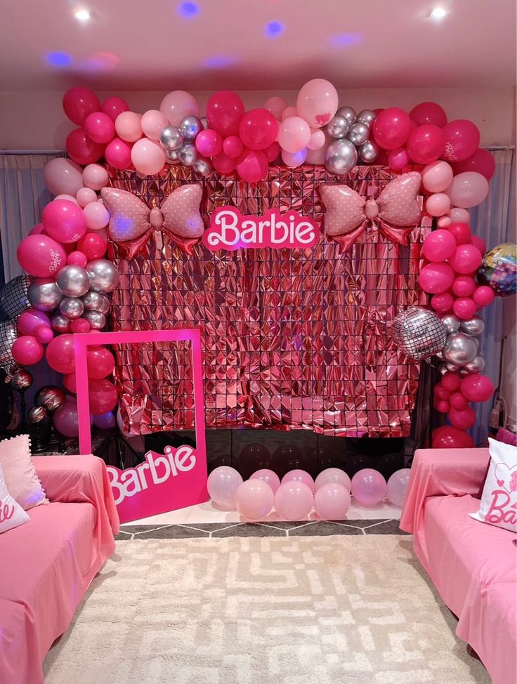 a pink and silver themed party with balloons