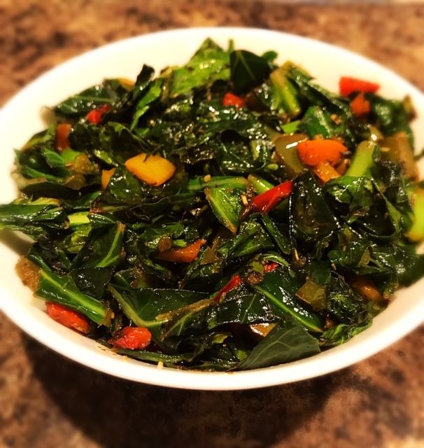 a white bowl filled with green vegetables on top of a counter