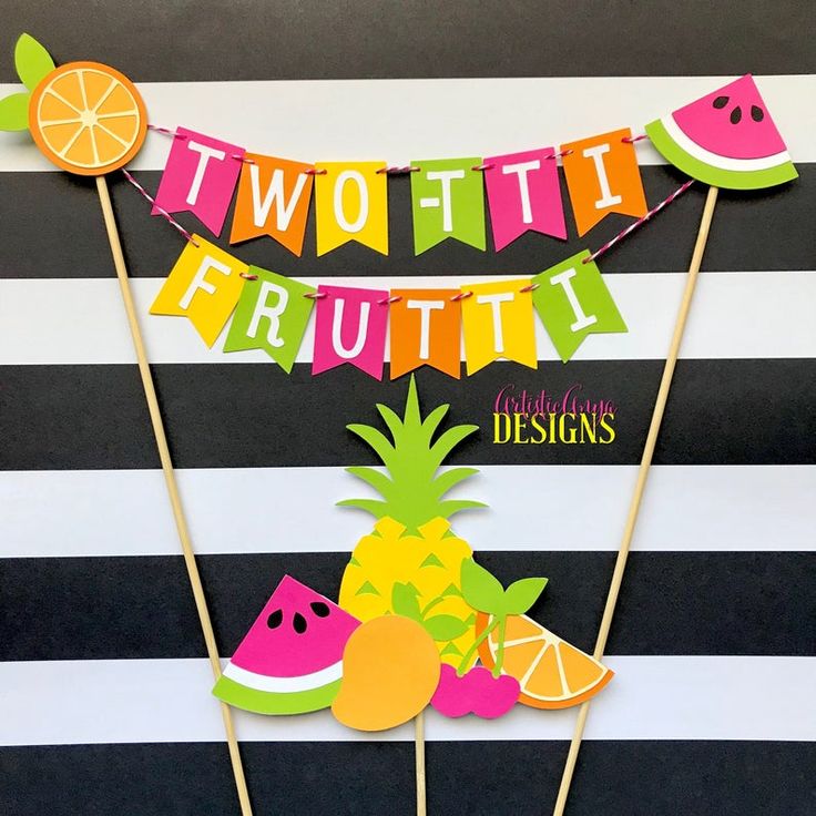 there is a cake topper made to look like two fruit on sticks with the words, twottit frutti