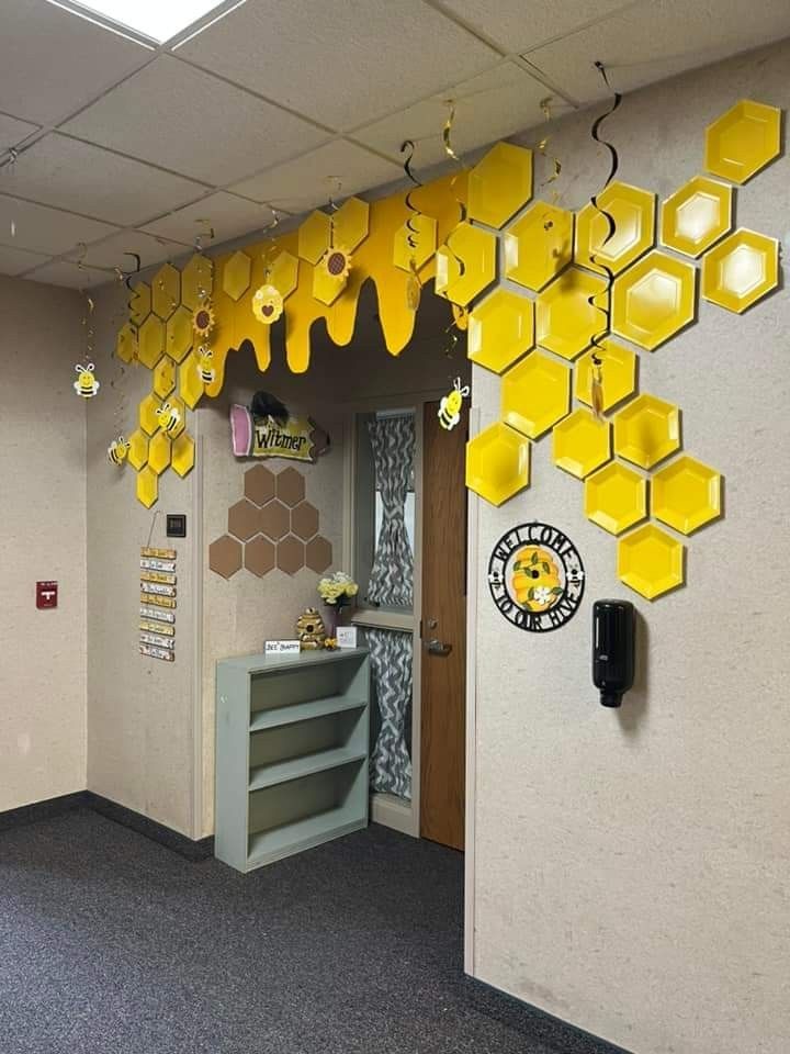 an office decorated with yellow honeycombs hanging from the ceiling and on the wall