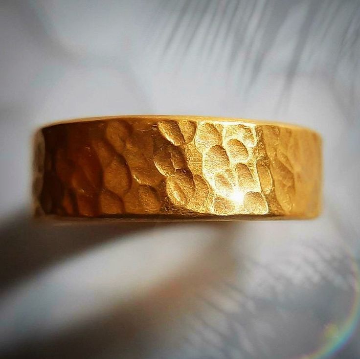 This is a thick and hefty solid 24k gold band with a hammered finish. The ring is approximately 6 MM wide. 24k gold is relatively soft, but the thickness and irregular handmade finish makes this ring wearable. This is a serious chunk of gold, and the color of real 24k gold really has no match, it is absolutely beautiful. Even if you look for one, there are not many rings available like this. The size is an 9, but I can make it any size. Also, I can make this in 22k gold, which is slightly more d Gold Hammered Bands For Promise Ring, Handmade Gold Rings With Thick Band, Handmade Gold Rings For Marriage, Gold Hammered Wide Band Ring For Anniversary, Gold Thick Band With Adjustable Fit, Gold Adjustable Thick Band, Adjustable Gold Wide Band Wedding Ring, Adjustable Gold Wide Band Ring For Wedding, Adjustable Thick Gold Band