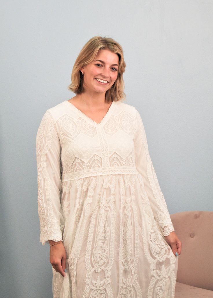 This intricately detailed lace dress is a perfect choice for a temple dress or for any special occasion. This dress has a v-neckline, 2 side pockets and is fully lined. It is an easy pull over style with one button keyhole back. Care instructions: Hand wash cold, do not bleach, hang to dry. Fabric Content: Outside: 100% cotton lace Liner: 100% polyester Small: 38" bust Medium: 41" bust Large: 44" bust XL: 46" bust Model is wearing a size Medium #1038