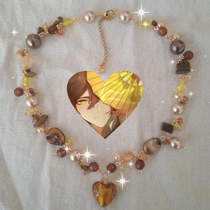 a necklace with an image of a woman holding a parasol in the shape of a heart