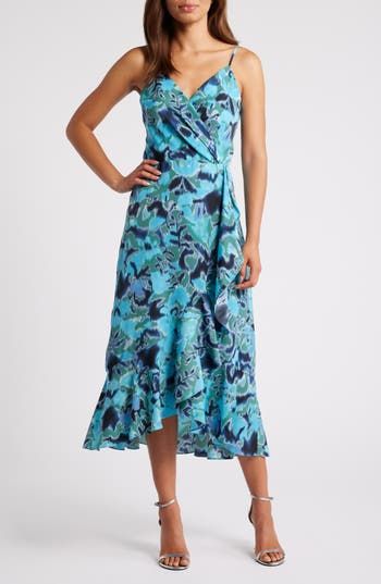 This sleeveless midi, fashioned with a wrapped bodice and a ruffled high/low skirt, is sure to be a warm-weather favorite. 33" to 41 1/2" center front length (size Medium) Hidden back-zip closure Surplice V-neck Adjustable straps Lined 99% polyester, 1% spandex Machine wash, line dry Imported Blue V-neck Wrap Dress With Ruffles, Blue Floral Print Maxi Dress With Asymmetrical Hem, Blue Midi Dress With Asymmetrical Floral Print Hem, Sleeveless Floral Wrap Dress For Vacation, Green Sleeveless Wrap Dress, Blue Wrap Dress With Surplice Neckline For Summer, Blue Wrap Dress With Surplice Neckline For Beach, Blue Surplice Neckline Wrap Dress For Beach, Blue Sleeveless Midi Dress With Ruffles