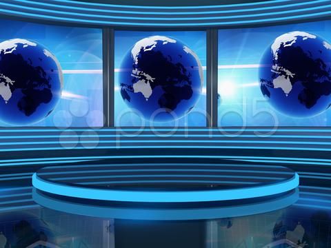 an empty news studio with three blue globes on the wall