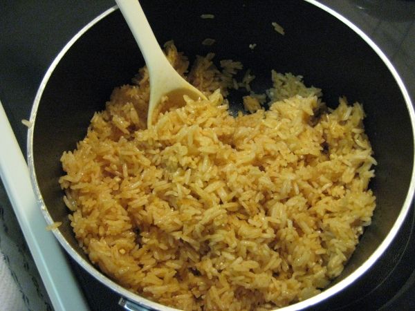 a pan filled with rice on top of a stove