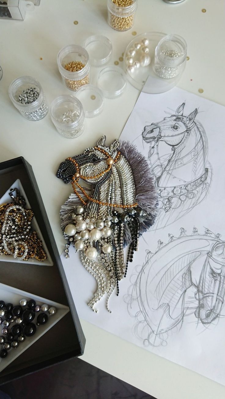 a table topped with lots of beads and jewelry