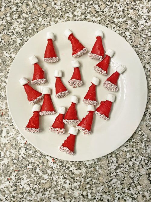 a white plate topped with red and white santa hats