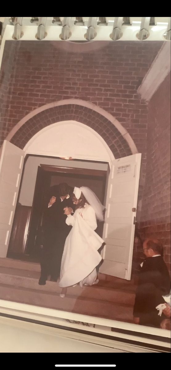 an old photo of a bride and groom exiting the church