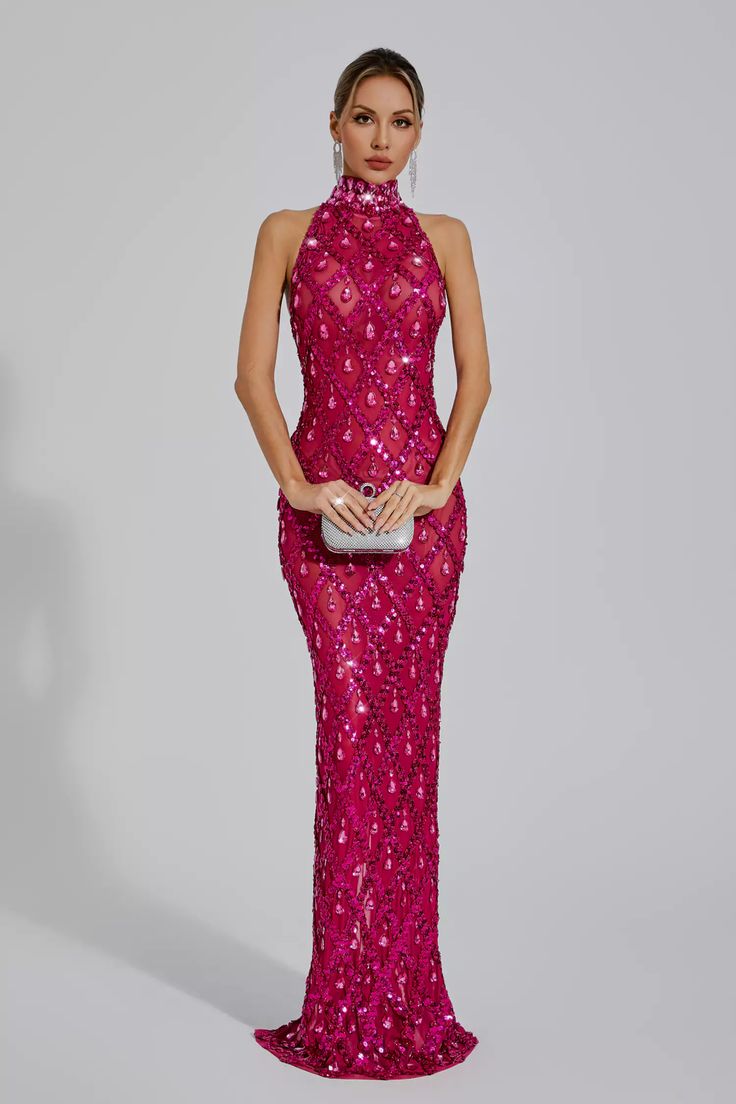 a woman wearing a pink gown with sequins on the skirt and high neck