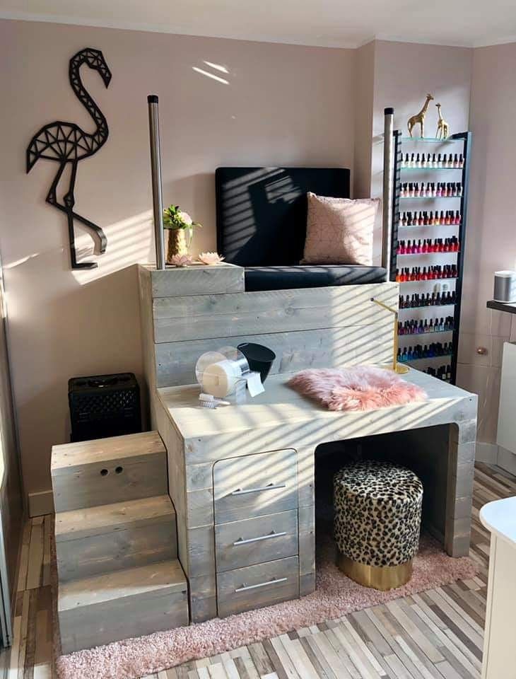 a room that has some kind of furniture in it, and is decorated with pink accents