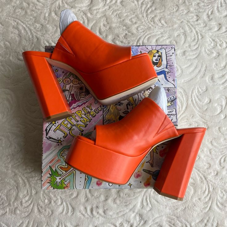 Brand New, Never Used Only Tried On In Store. Size Is 9.5 But Fits A 9-9.5, I’m A 9 And They Fit Me! Fall In Luv With The The Luna Luv Platform Mule In Orange! These Chunky Open-Toe Platforms Are Both Playful And Elevated, And Pair Perfectly With Any Flare Style Pant. Pair It With A Light Washed Jean For A Daytime Look Or Channel Your Y2k Vibes And Pair Them With Your Favorite Mini Skirt! Faux Leather Upper With Manmade Sole Slip-On Styling Leather Lining Approx 5.25 Inch Heel Approx 2 Inch Plat Orange Platform Heels With Round Toe, Orange High Heel Platform Shoes, Trendy Wedge Heels With Branded Insole, Orange Platform Heels With High Heel, Orange Platform High Heels, Orange Platform Heels With Closed Toe, Platform Open Toe Heels For Fall, Bold Leather Heels With Block Heel, Trendy Orange Wedge Heels