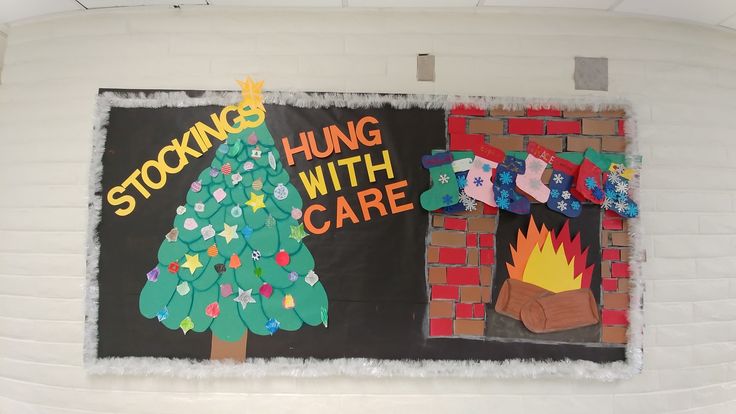 a bulletin board with christmas decorations and stockings hung on the wall next to a fire place