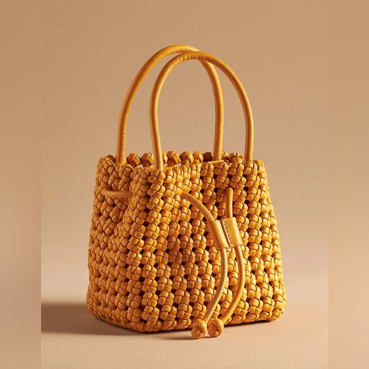 Polyurethane Removable Crossbody Strap One Inner Zip Pocket Drawstring Closure Dimensions 6.5"H, 6.5"L, 5"D 4.5" Handle Drop 19-24" Strap Drop Chic Yellow Crochet Bag For Daily Use, Chic Yellow Crochet Bag, Chic Yellow Crochet Tote Bag, Spring Yellow Bucket Bag With Adjustable Strap, Yellow Crochet Bag With Braided Handles For Shopping, Trendy Yellow Pouch Bucket Bag, Trendy Yellow Bucket Bag With Detachable Strap, Yellow Shoulder Bucket Bag For Spring, Trendy Yellow Bucket Bag