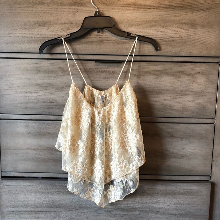 Brand New With Tag Sparkly Gold Lacey Crop Top. Sheer And Has Golden Shimmery Lace. Purchased At Urban Outfitters, Never Worn. Perfect For The Holidays Or Any Occasion. Soft And Feminine Top Summer Beige Tops With Delicate Lace, Summer Beige Delicate Lace Top, Beige Delicate Lace Summer Tops, Cream Lace Tops For Summer, White Spaghetti Strap Tops With Delicate Lace, Summer Cami Crop Top With Delicate Lace, White Delicate Lace Crop Top For Summer, Cream Camisole Top For Beach, Cream Lace Camisole Top