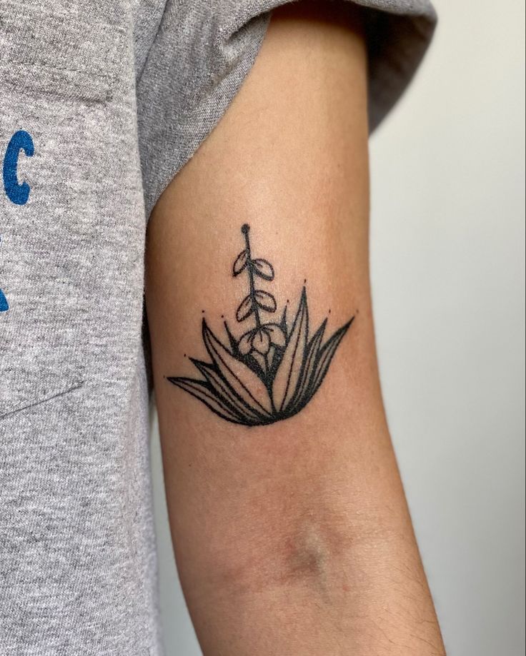 a woman's arm with a flower tattoo on the left side of her arm