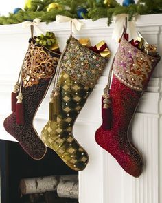 three christmas stockings hanging from a mantel