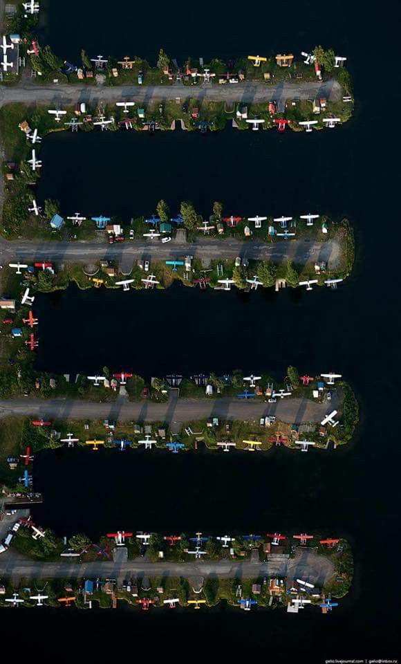 an aerial view of several airplanes parked on the tarmac at night or day time