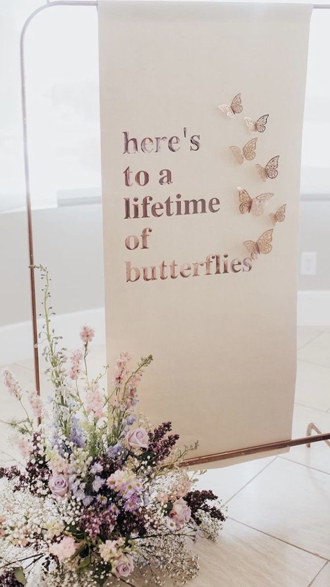 there is a sign that says here's to a life time of butterflies on it