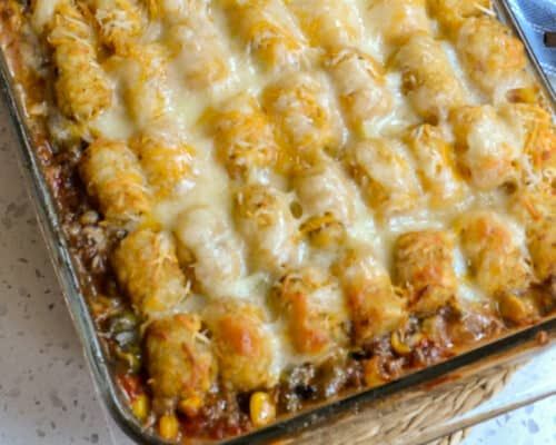 a casserole dish with meat and cheese on top, ready to be eaten