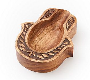 a wooden bowl with an ornate design on it