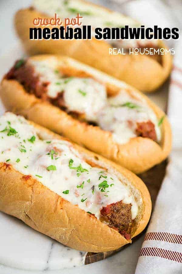 two hot dogs with meat and cheese are on a plate