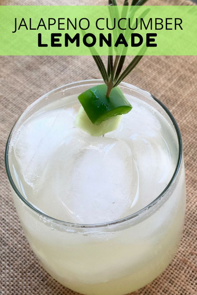 a close up of a drink in a glass on a table with the words jalapeno cucumber lemonade